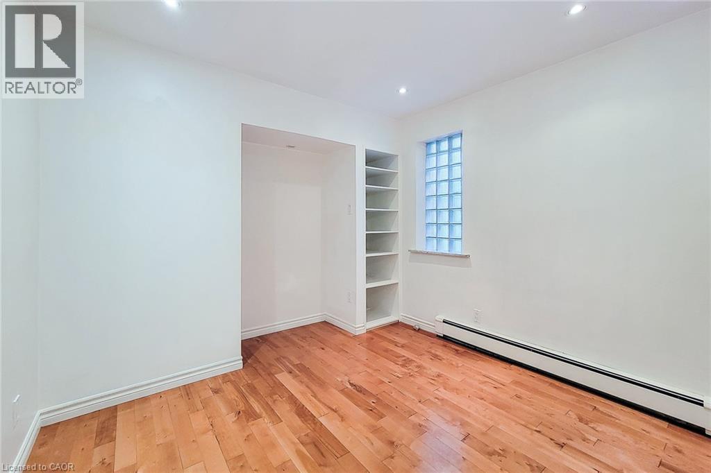 Bedroom featuring baseboard heating, light wood-style floors, and recessed lighting and ensuite. - 156 Park Row S, Hamilton, ON - Indoor Photo Showing Other Room