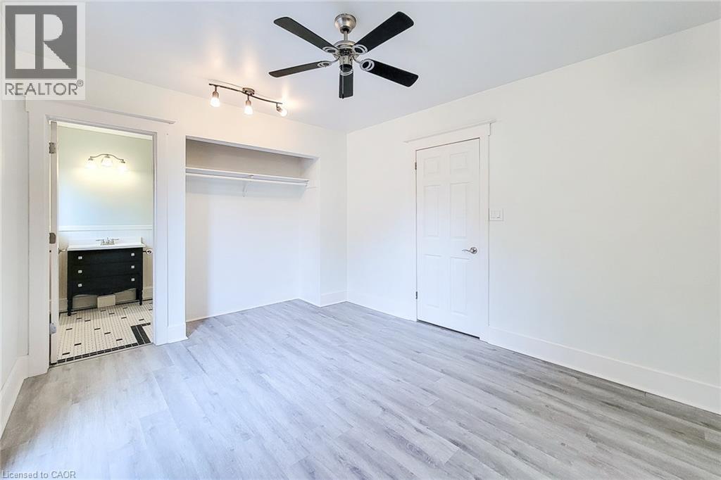 Unfurnished bedroom with wood finished floors and an ensuite bath. - 156 Park Row S, Hamilton, ON - Indoor Photo Showing Other Room