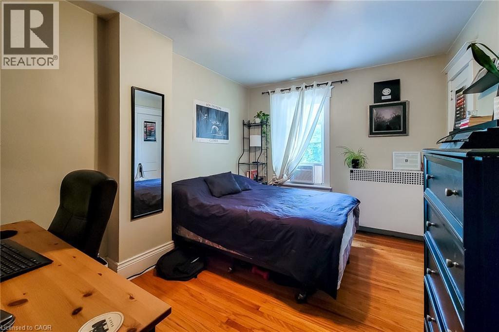 Upper Bedroom featuring radiator, light wood finished floor. - 156 Park Row S, Hamilton, ON - Indoor Photo Showing Bedroom