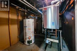 Utility room with water heater and gas fired boiler. -