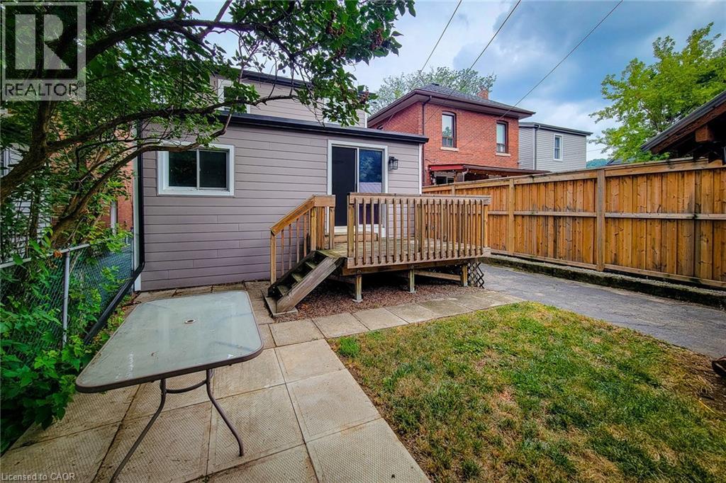Rear view of property featuring a patio area and a wooden deck - 156 Park Row S, Hamilton, ON - Outdoor With Deck Patio Veranda With Exterior