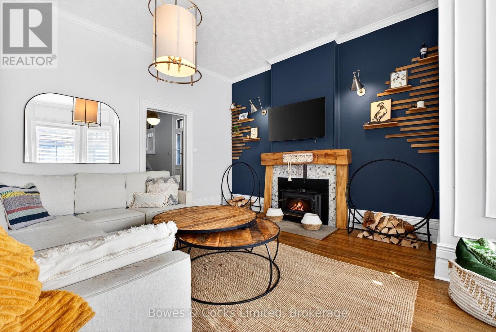 82 Queen Street, Selwyn, ON - Indoor Photo Showing Living Room With Fireplace