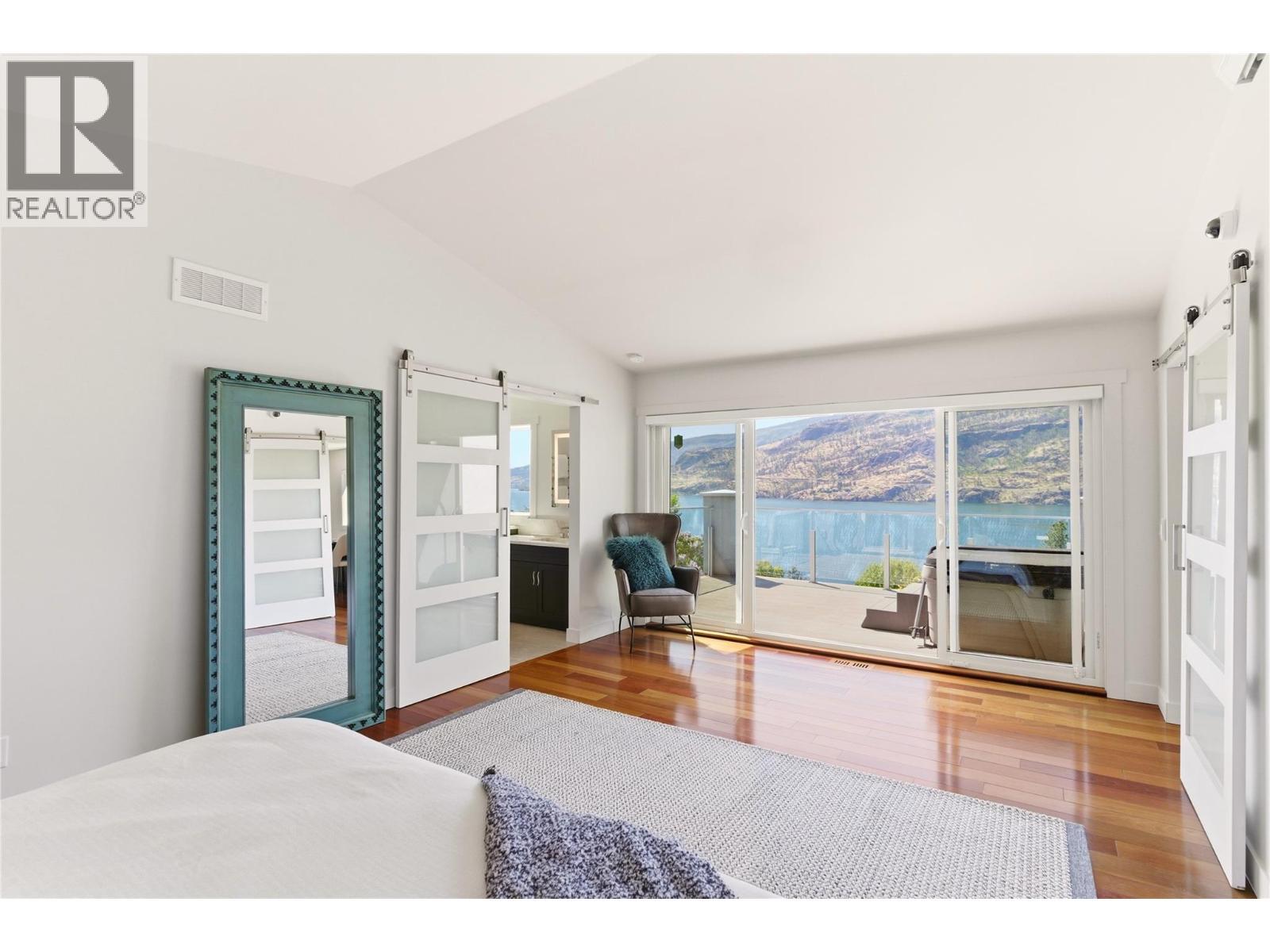 Expansive windows to enjoy the views of Okanagan Lake - 2090 Bennett Road, Kelowna, BC - Indoor Photo Showing Bedroom