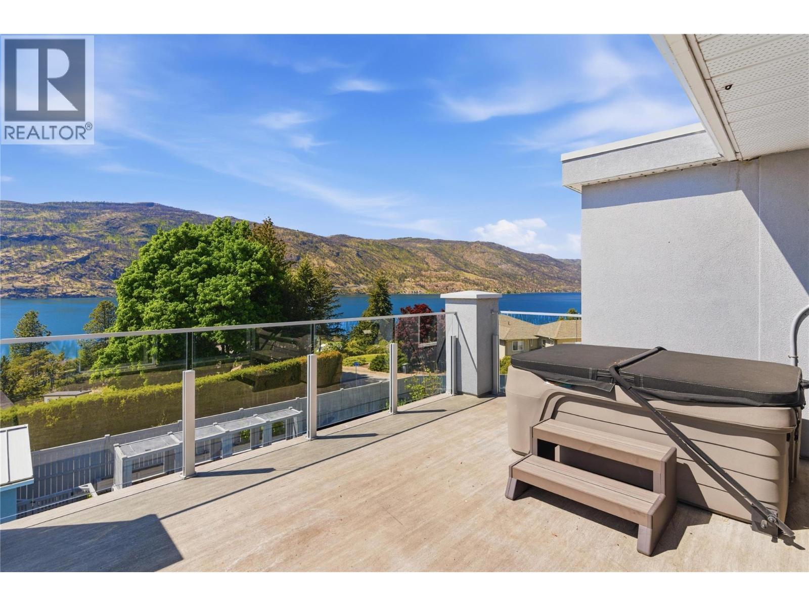 Front sun deck-connects to the second level/primary bedroom with a hot tub for evening relaxation - 2090 Bennett Road, Kelowna, BC - Outdoor With Body Of Water With Deck Patio Veranda With Exterior