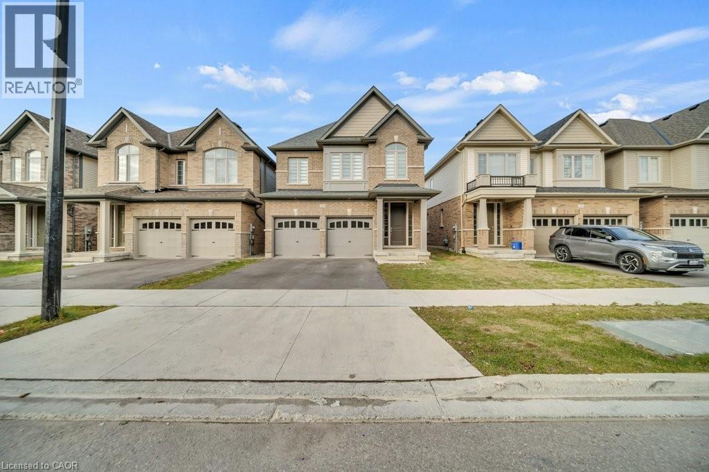 View of front of home featuring driveway, brick siding, and a garage - 285 Broadacre Drive, Kitchener, ON - Outdoor With Facade