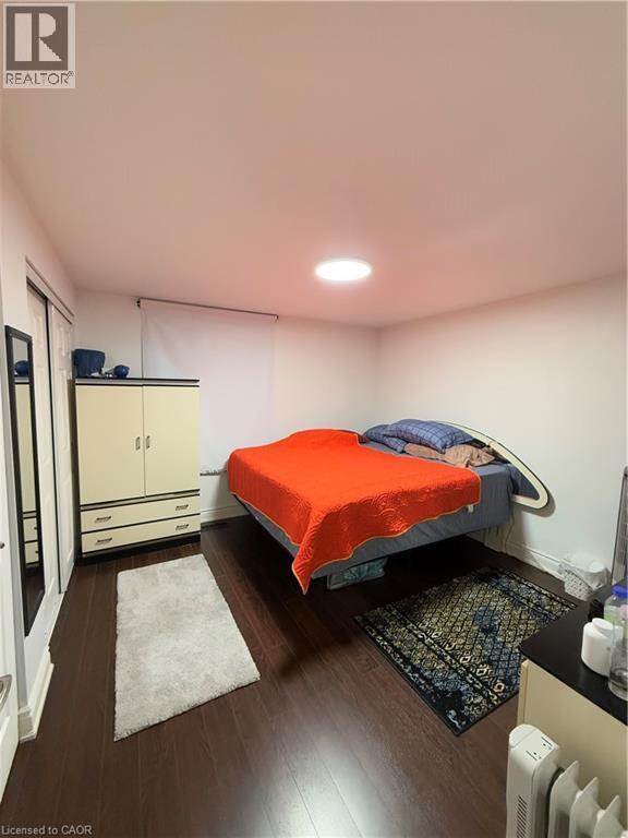 Room featuring dark wood-finish flooring, white walls, and a recessed ceiling light fixture - 181 Thaler Avenue, Kitchener, ON