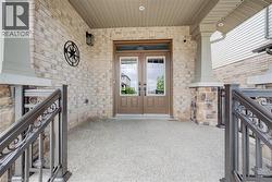 Double entry doors with divided lites, framed by light-toned brick and stone veneer -