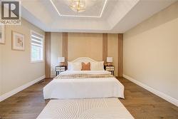 Recessed tray ceiling with integrated lighting and a decorative chandelier -