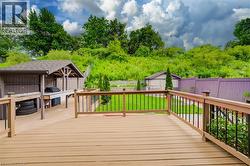 Expansive outdoor deck with composite wood-finish flooring and black metal balusters -