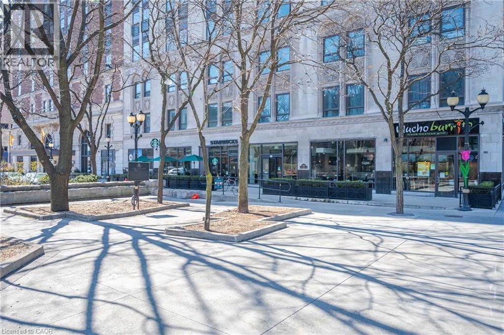 Commercial storefronts featuring large display windows and pedestrian access - 112 King Street E Unit# 907, Hamilton, ON