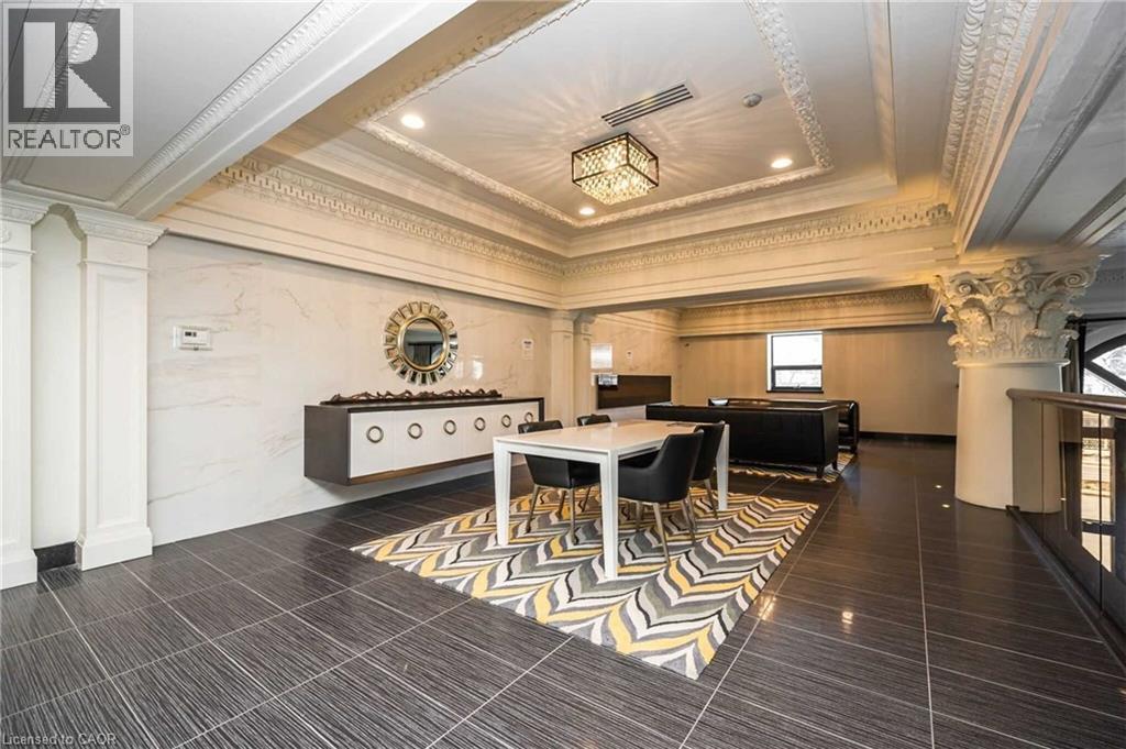 Recessed ceiling with decorative molding, dark tile flooring, and a floating console cabinet - 112 King Street E Unit# 907, Hamilton, ON