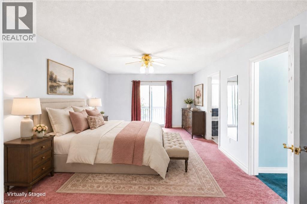 Spacious room featuring carpeting, a ceiling fan with light fixture, and a sliding glass door leading to an exterior balcony - 381 Kerman Avenue, Grimsby, ON - Indoor Photo Showing Bedroom