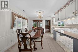 Dining area featuring white wainscoting and vertical paneling -