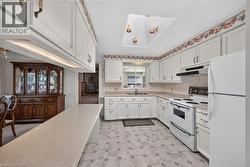 Kitchen featuring white cabinetry, light-toned countertops, and hexagonal tile flooring -