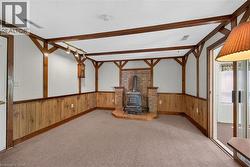 Interior room featuring a brick wood-burning stove with a raised hearth -
