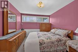 Interior space featuring pink walls and white wainscoting -