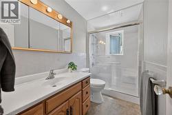 Bathroom featuring a wood-finish vanity with an integrated sink and chrome faucet -