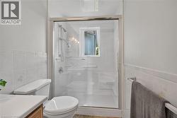 Shower enclosure with clear glass doors and chrome hardware -