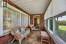 Enclosed porch featuring brick walls and flagstone flooring -