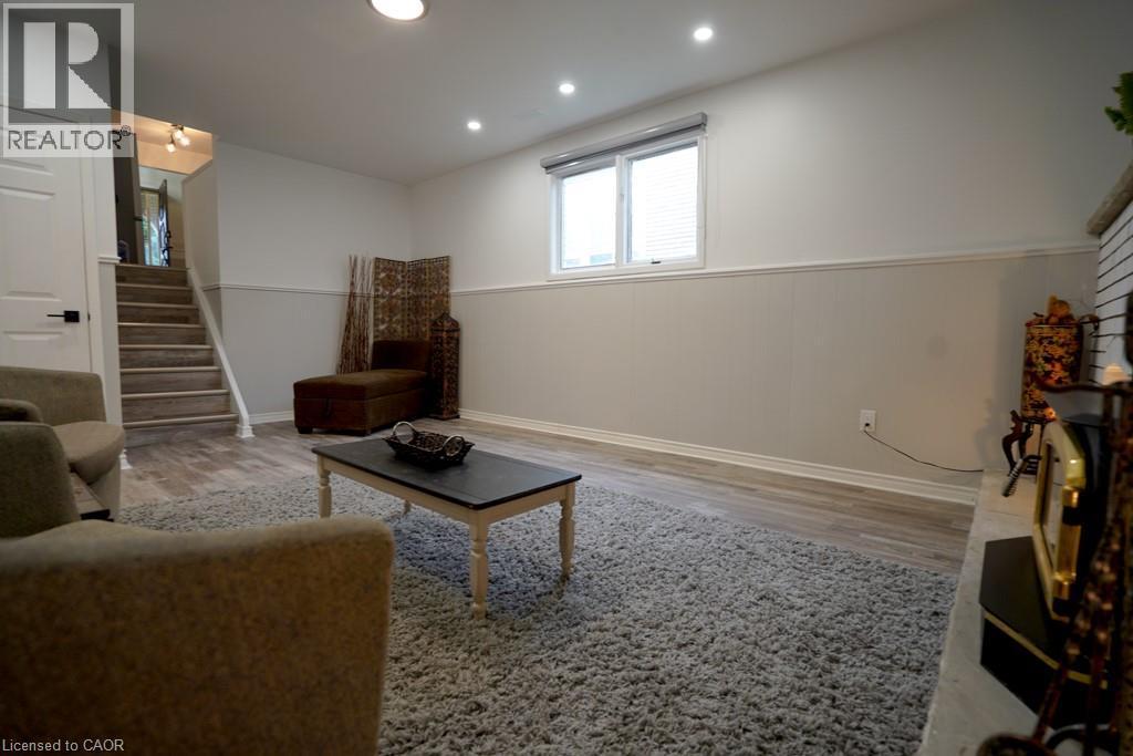 Spacious living area featuring light wood-finish flooring and a neutral color palette - 147 Muriel Crescent, London, ON