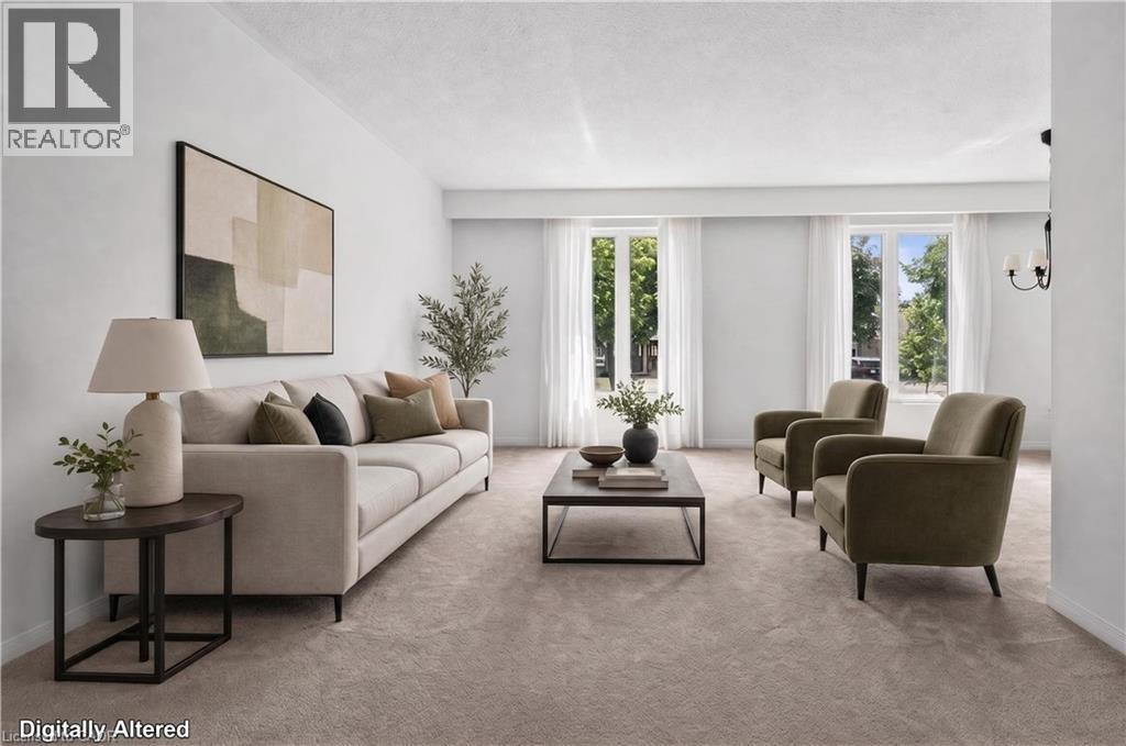Virtually Staged Light-filled living area featuring plush carpeting and white painted walls - 5051 Brady Avenue, Burlington, ON