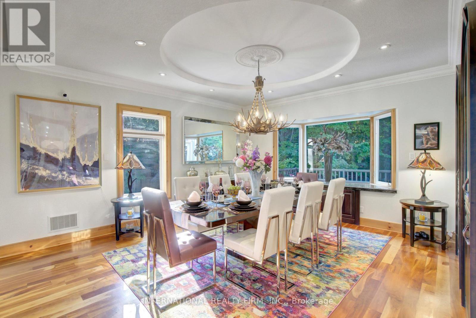 Elegant formal dining room with rich hardwoods. - 6 Pinehurst Lane, Springwater, ON - Indoor Photo Showing Dining Room