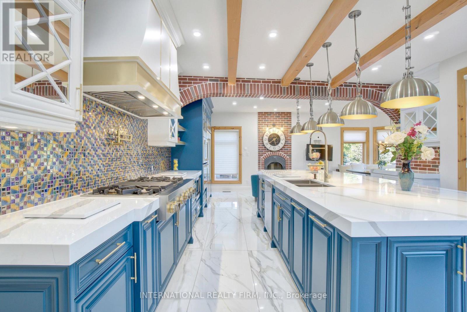 Exquisite backsplashes, lighting and brick arches. - 6 Pinehurst Lane, Springwater, ON - Indoor Photo Showing Kitchen With Double Sink With Upgraded Kitchen