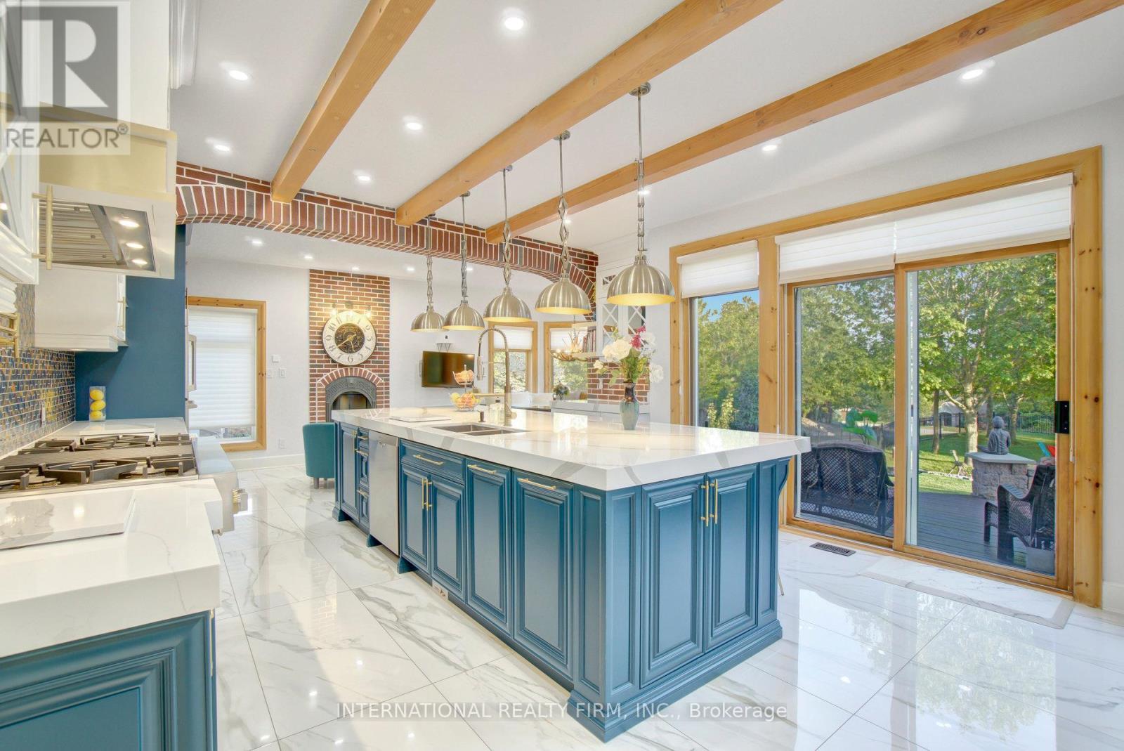 Fabulous chef's kitchen with sliding doors to deck - 6 Pinehurst Lane, Springwater, ON - Indoor Photo Showing Kitchen