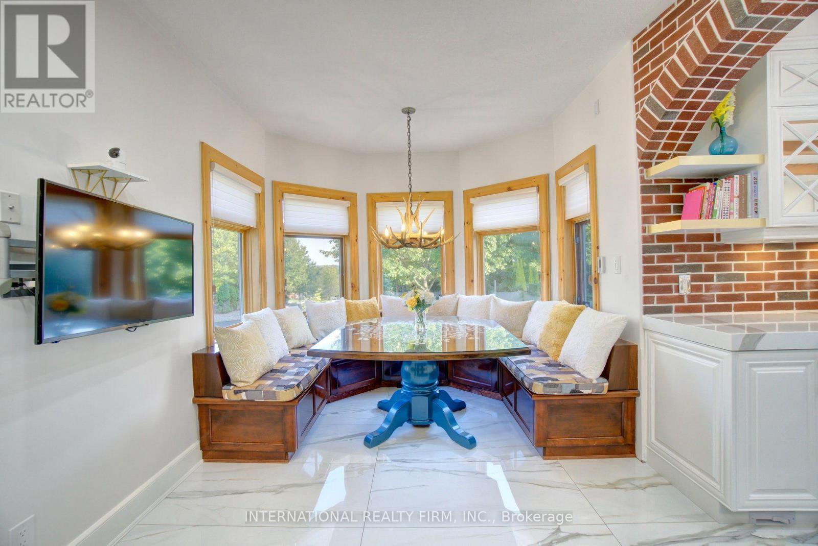 Bright eat-in breakfast nook with custom benches. - 6 Pinehurst Lane, Springwater, ON - Indoor