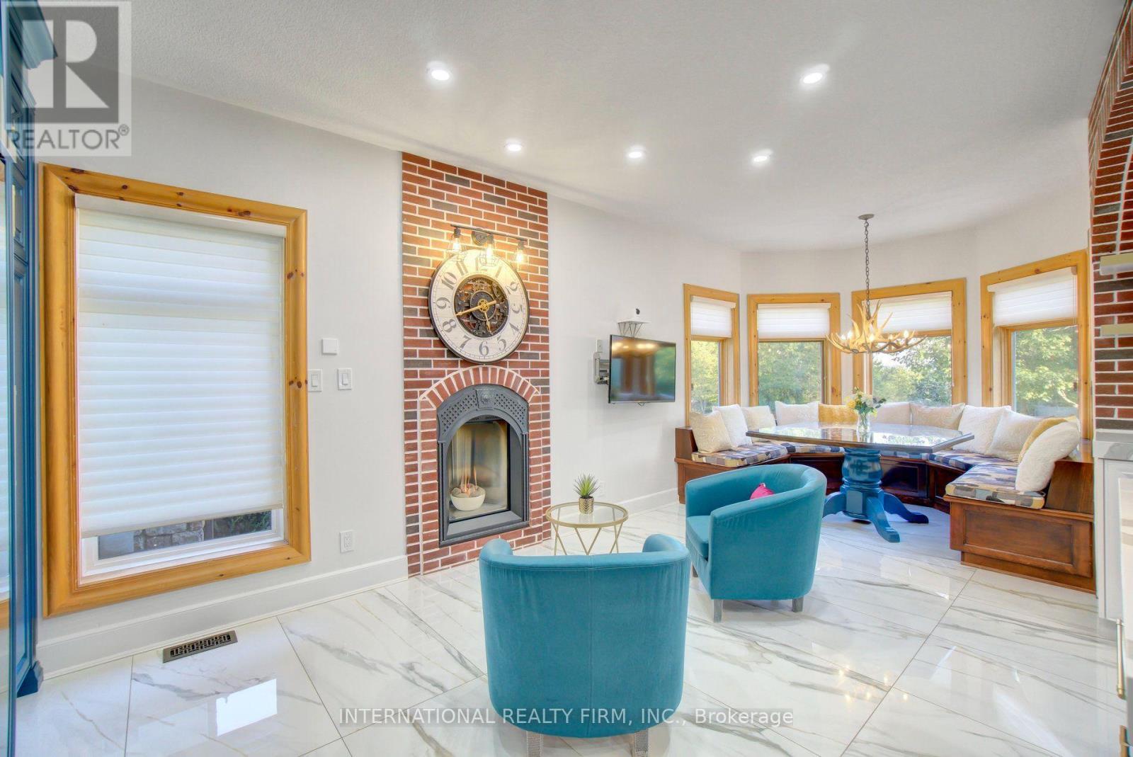 Cozy kitchen lounge area with gas fireplace. - 6 Pinehurst Lane, Springwater, ON - Indoor Photo Showing Living Room With Fireplace