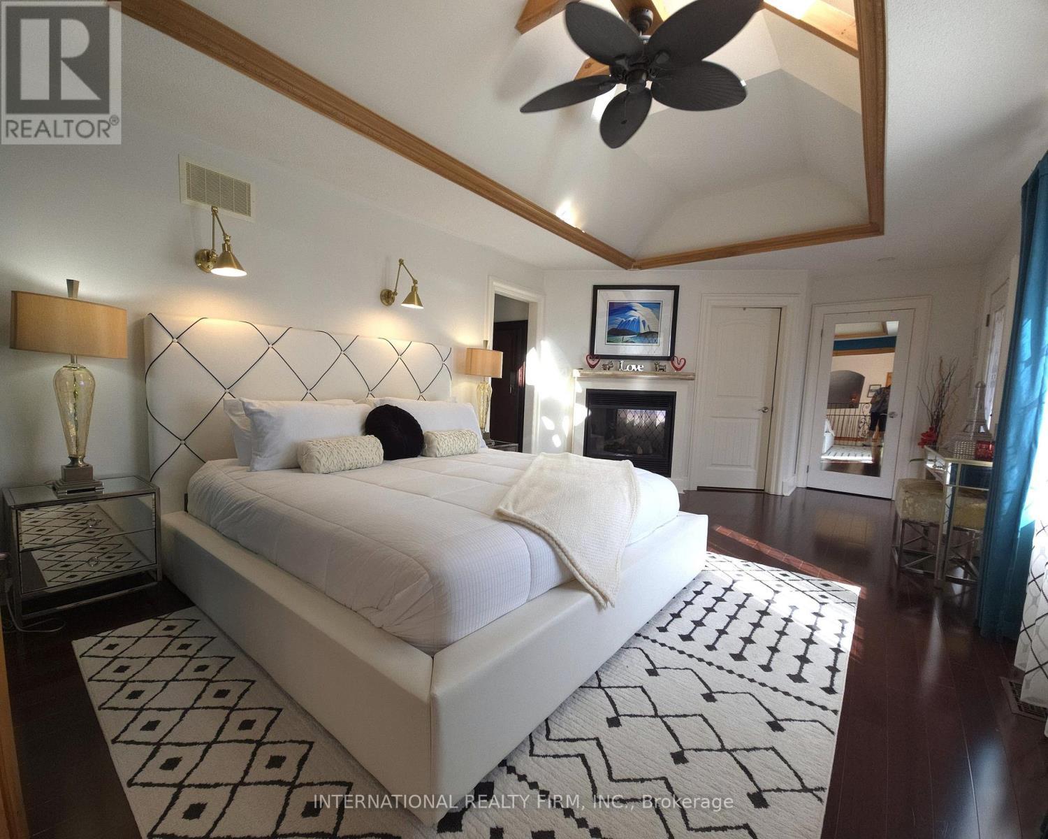 Spacious primary retreat with two walk-in closets. - 6 Pinehurst Lane, Springwater, ON - Indoor Photo Showing Bedroom