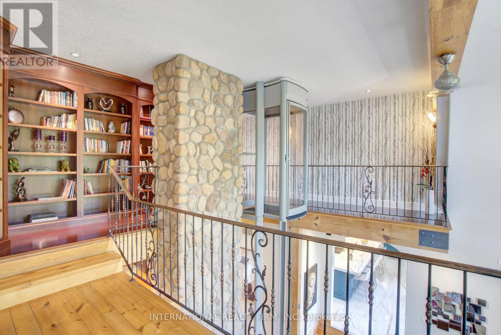 Custom built-in library & convenient elevator-lift - 6 Pinehurst Lane, Springwater, ON - Indoor Photo Showing Other Room