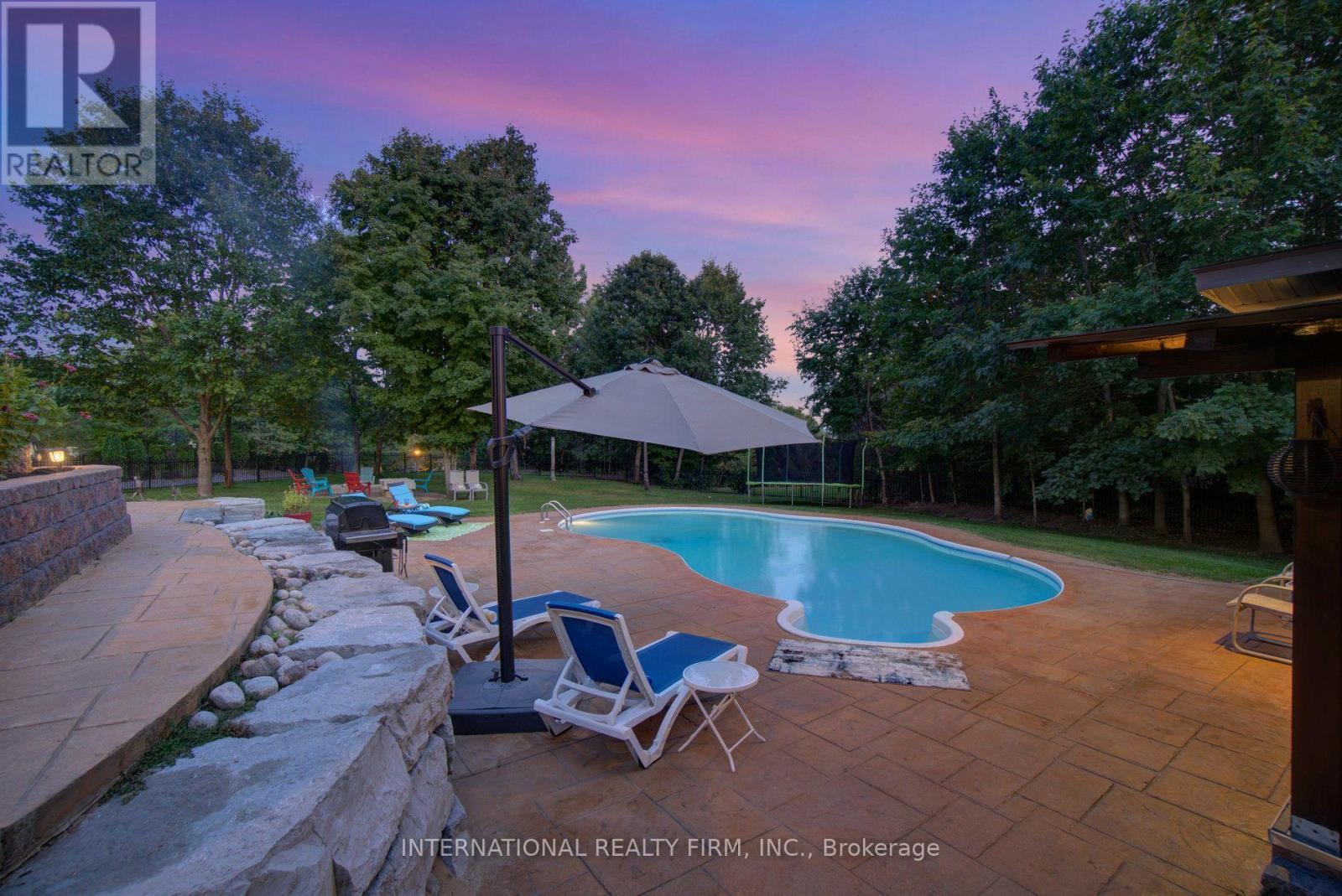 Stunning saltwater pool & premium stone landscape. - 6 Pinehurst Lane, Springwater, ON - Outdoor With In Ground Pool With Backyard