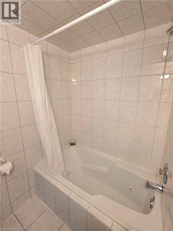 Jetted soaking tub with a tiled surround and chrome fixtures - 2373 E King Street E Unit# 37, Hamilton, ON