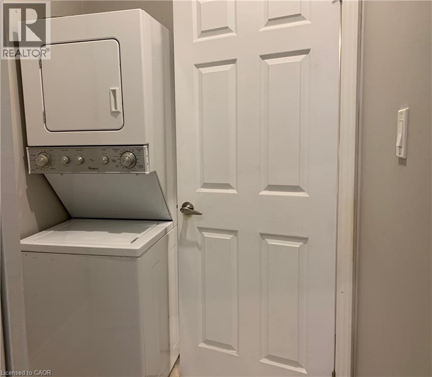 Stacked washer and dryer unit, featuring a white finish and a compact design - 405 Macnab Street N, Hamilton, ON