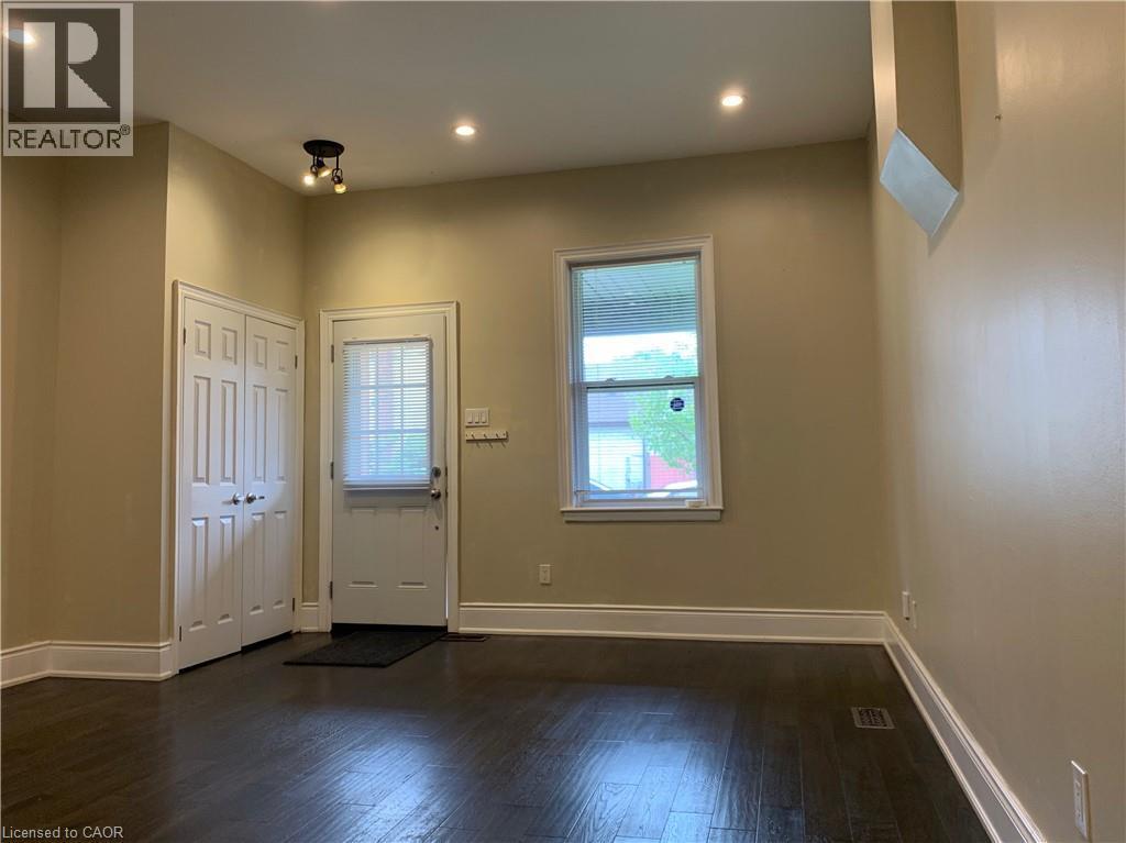 Unit 2 Living Room featuring dark wood-finish flooring and neutral wall tones - 405 Macnab Street N, Hamilton, ON
