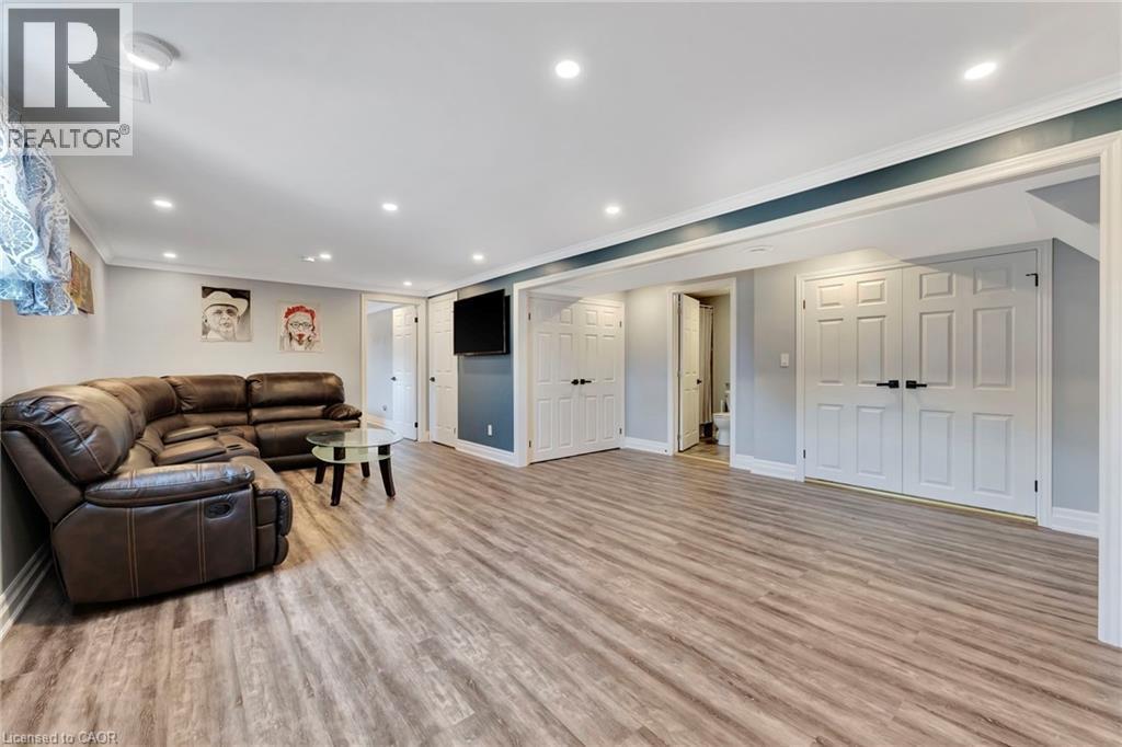 Spacious room featuring wood-finish flooring, recessed lighting, and crown molding - 192 Myers Road, Cambridge, ON