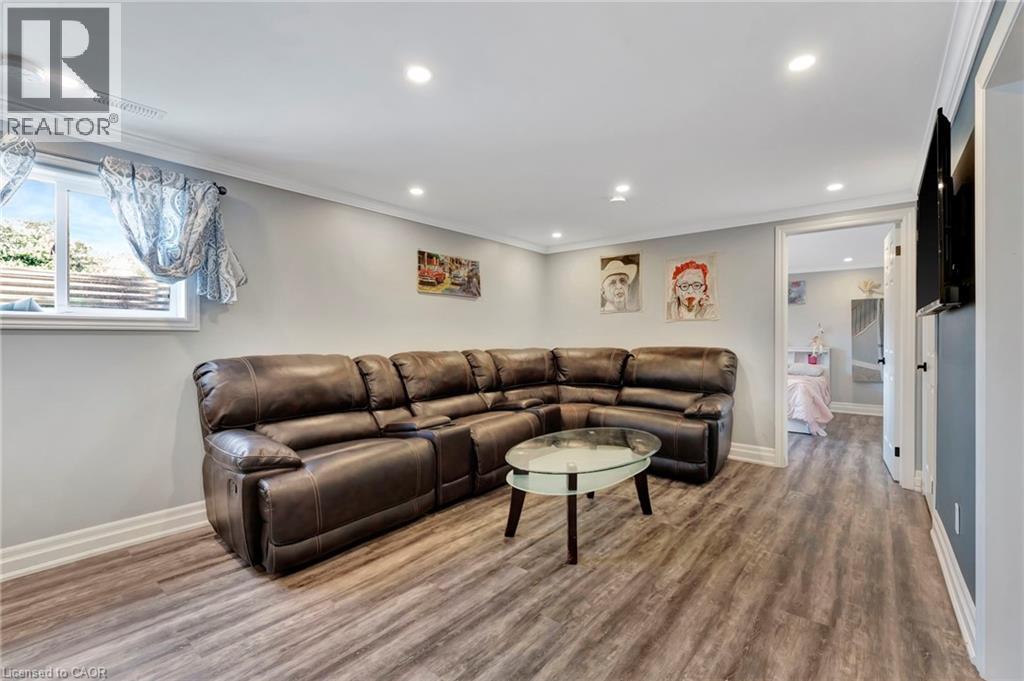 Spacious room with wood-finish flooring, recessed lighting, and crown molding - 192 Myers Road, Cambridge, ON
