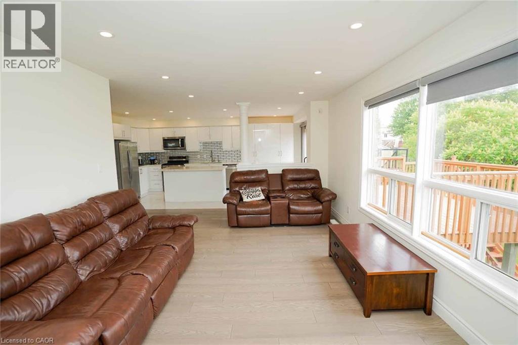 Open-concept living space featuring light wood-finish flooring and recessed lighting - 187 Adler Drive, Cambridge, ON - Indoor Photo Showing Living Room