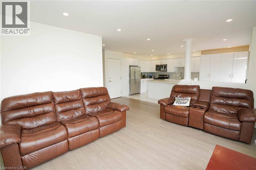 Open-concept living space featuring wood-finish flooring and recessed lighting - 187 Adler Drive, Cambridge, ON - Indoor Photo Showing Living Room