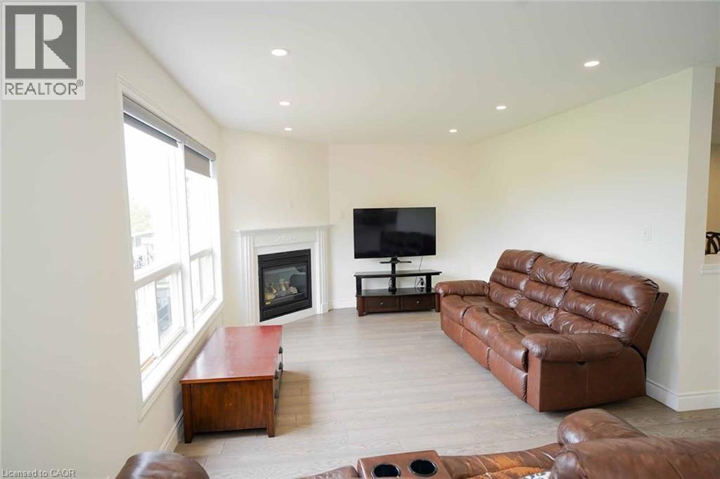 Living area with light-colored walls and recessed lighting - 187 Adler Drive, Cambridge, ON - Indoor Photo Showing Living Room With Fireplace