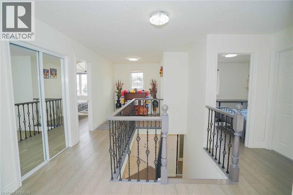 Upper-level hallway featuring light wood-finish flooring and white walls - 187 Adler Drive, Cambridge, ON - Indoor Photo Showing Other Room