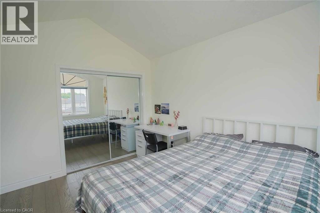 Room featuring wood-finish flooring, a vaulted ceiling, and white painted walls - 187 Adler Drive, Cambridge, ON - Indoor Photo Showing Bedroom