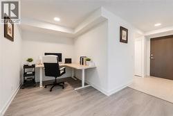 Flexible area with recessed lighting and light wood-finish flooring - 