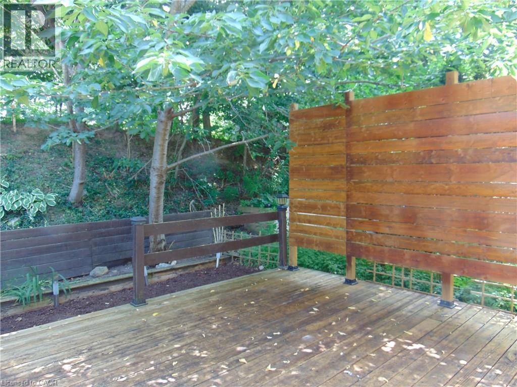 Expansive wood deck with a horizontal plank privacy screen - 214 Snowdrop Crescent, Kitchener, ON