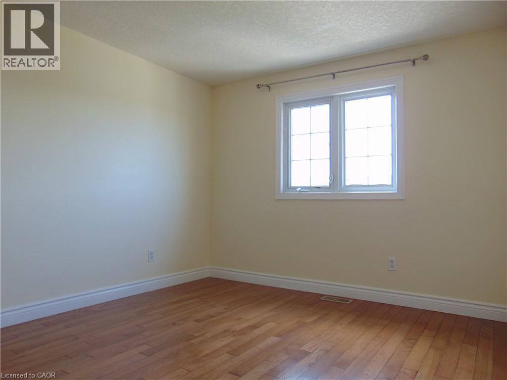 Room featuring light-colored walls and wood-finish flooring - 214 Snowdrop Crescent, Kitchener, ON