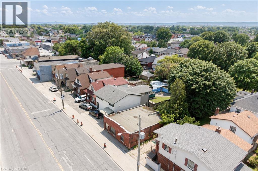 Aerial perspective showcasing a mixed-use neighborhood with residential and commercial properties - 1274 Barton Street E, Hamilton, ON