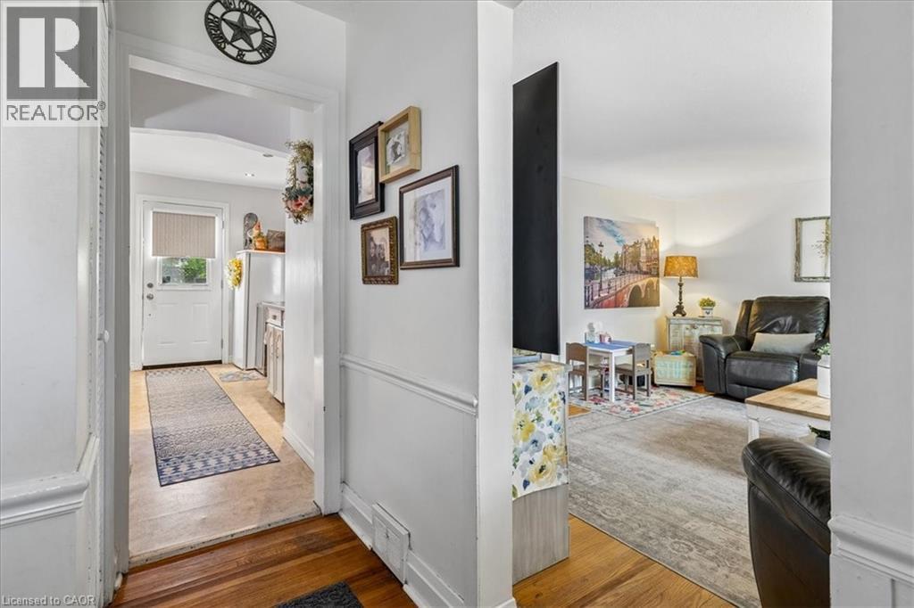 Hardwood flooring in main areas with a white trim package - 80 Maclennan Avenue, Hamilton, ON - Indoor Photo Showing Other Room