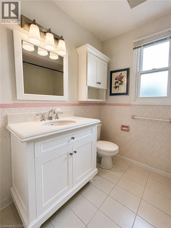 White vanity with an integrated sink and chrome fixtures - 80 Maclennan Avenue, Hamilton, ON - Indoor Photo Showing Bathroom