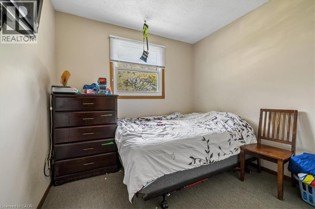 Neutral tone wall paint with a single window featuring horizontal blinds - 80 Maclennan Avenue, Hamilton, ON